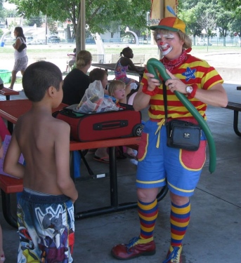 Sally twisting balloons at an event in the park.