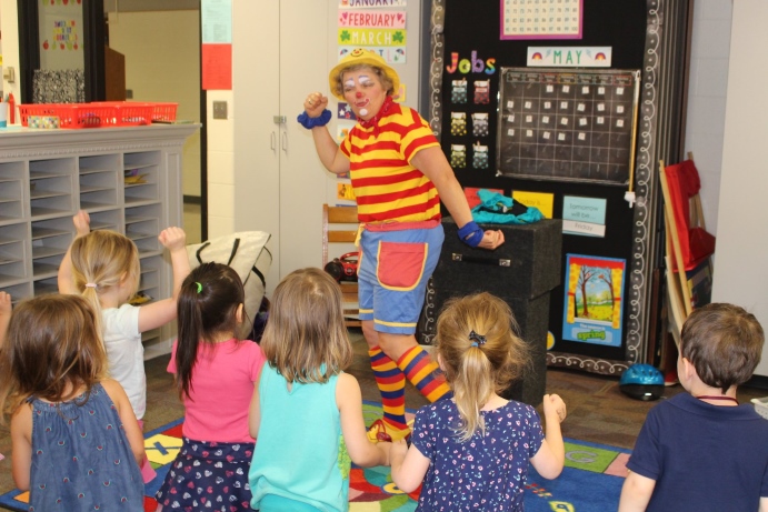 Silly Sally teaching preschoolers to get up and get moving.  Do you know the muscle man.